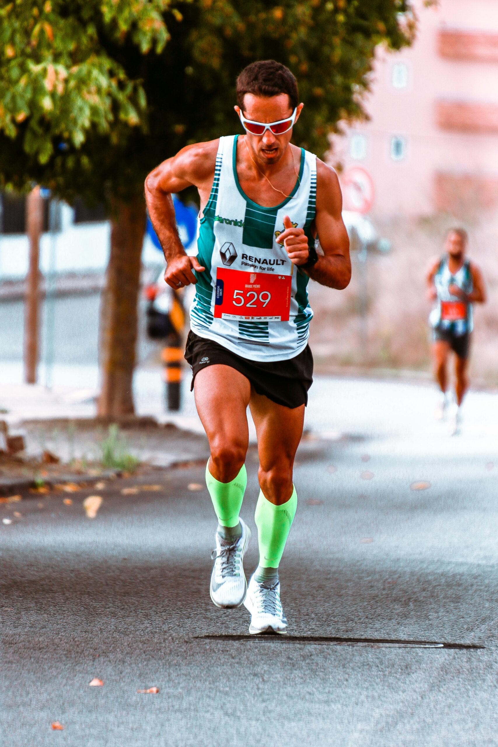 Male athlete competing in a street marathon, showcasing endurance and determination.